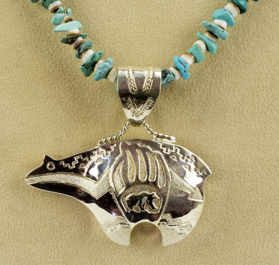 Navajo Sterling Heart line and Bear Paw Pendant: Measures 2 inches wide and 1.75 inches tall. Detailed Stamp design with Heart line and Bear Paw on front. Marked Sterling Silver and signed "A. Mariano". Weighs 17.2 Grams. Naive American, Indian, Sou