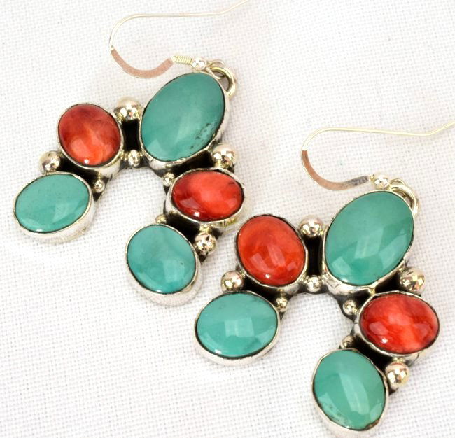 Geraldine James Turquoise & Spiny Oyster Earrings: Measures 2 inches long from the hook drop and 1.25 inches wide. These are done in a Naja style with Natural Turquoise and Spiny Oyster stones. Marked Sterling and Signed "G. James". Weigh 21.2 Grams.