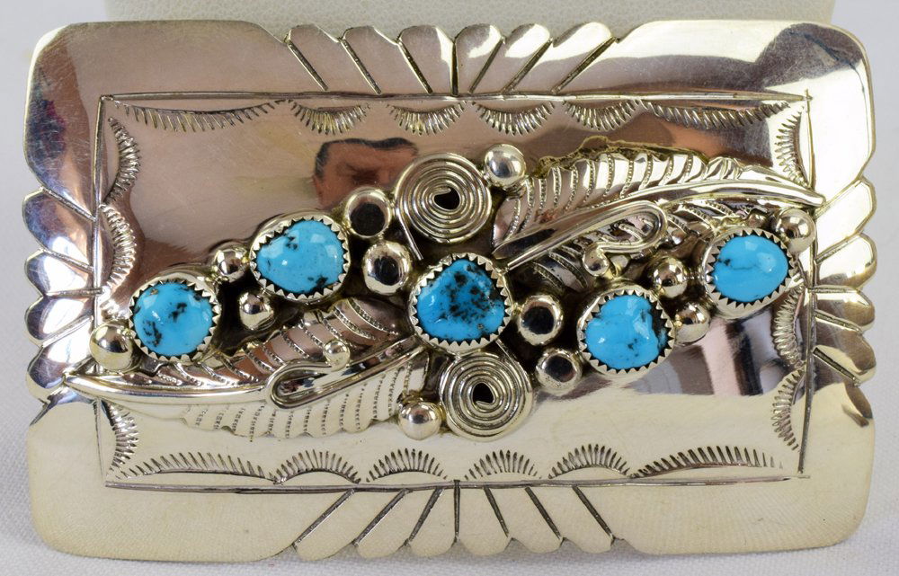 Wilbur Musket Sterling Belt Buckle w/Turquoise: Measuring 3.25 x 2 inches this piece has 5 Natural Turquoise Nuggets across the top with Feather and scroll detail and hand stamping. Marked Sterling and Hallmarked "WM". Weighs 41.1 Grams. Native Ame