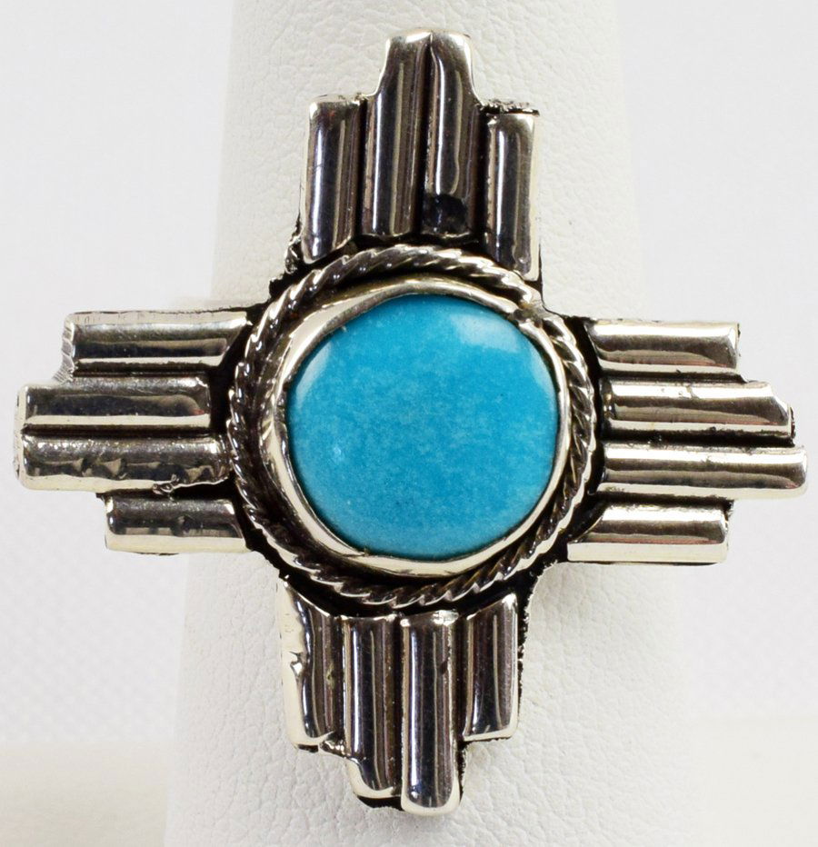 Native Amrican Sterling Zia Ring with Turquoise: Measures 1 1/8 inch square with a Natural Turquoise Center Stone. The symbol has sacred meaning to the Zia. Four is a sacred number which symbolizes the Circle of Life: four winds, four seasons, four