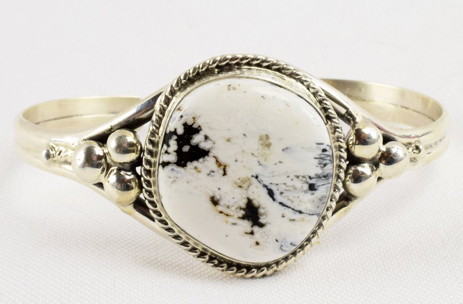 Marcella James Sterling White Buffalo Turquoise Bracele: Measures 1 1/8 inches wide with a Center Stone of White Buffalo Turquoise accented with a Rope frame and beads. The inside measures 5.5 inches plus an opening of 1 inch. Stamped Sterling and Signed "M