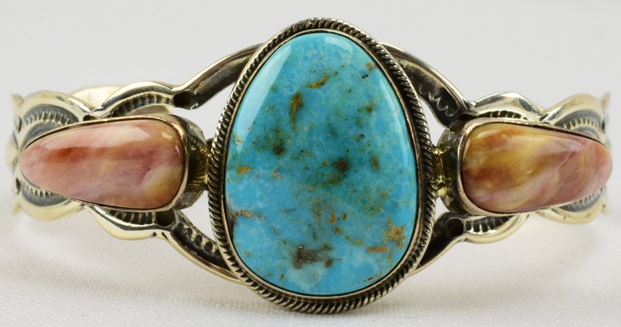 Ben Begaye Sterling Turquoise & Spiny Oyster Bracelet: Measures 1 1/8 inches wide with a Natural Turquoise Center stone accented with a Spiny Oyster piece on each side. Inside measures 5.5 inches plus a gap of 1.25 inches. Stamped Sterling and Signed "Ben