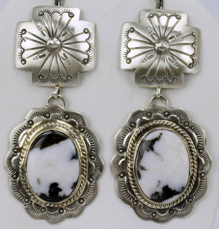 Marcella James Sterling White Buffalo Turq. Earrings: For pierced ears these measure 2.75 inches in length x 1.25 inches wide. They have a Stamped Cross Concho which sets on the ear lobe and drops down to a Natural White Buffalo Turquoise Stone. The ston