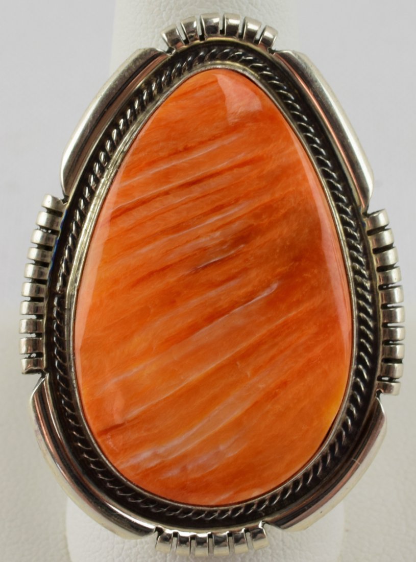 Russell Sam Sterling Spiny Oyster Ring: Measures 1 5/8 inches in length with a Natural Spiny Oyster center stone accented with a tiny rope design and a notched frame. This ring is large and heavy and has a wide band. Stamped Sterling and Si