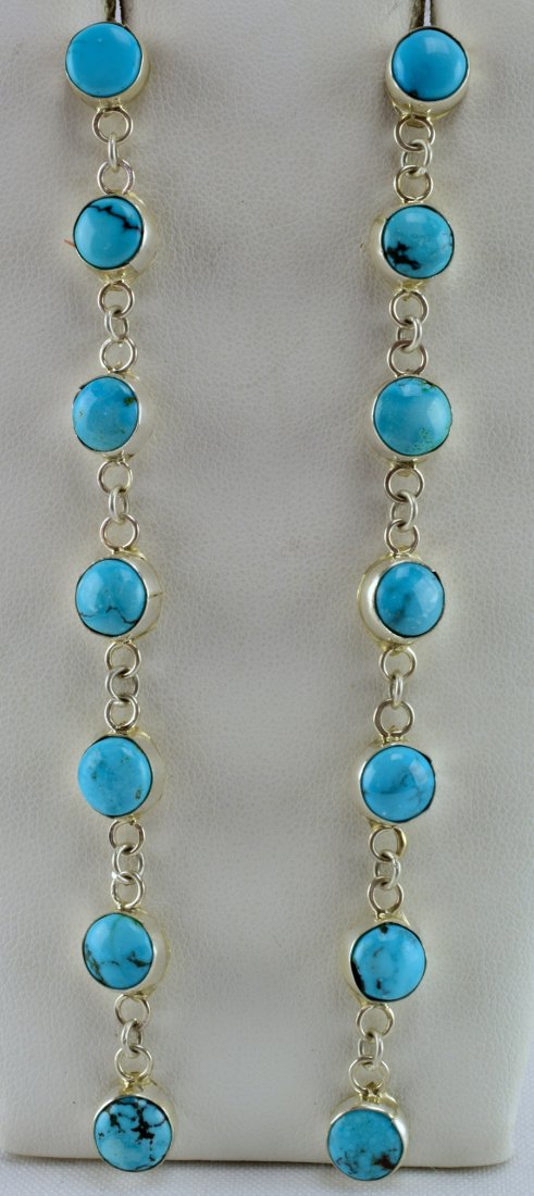 Navajo Sterling 4.5 inch Kingman Turquoise Earrings: For pierced ears and measureing 4.5 inches in length these earrings have Natural Kingman Cabochon Pieces in a line design. Simple and a lot of movement. Stamped Sterling on the back of one/Unsigned. W