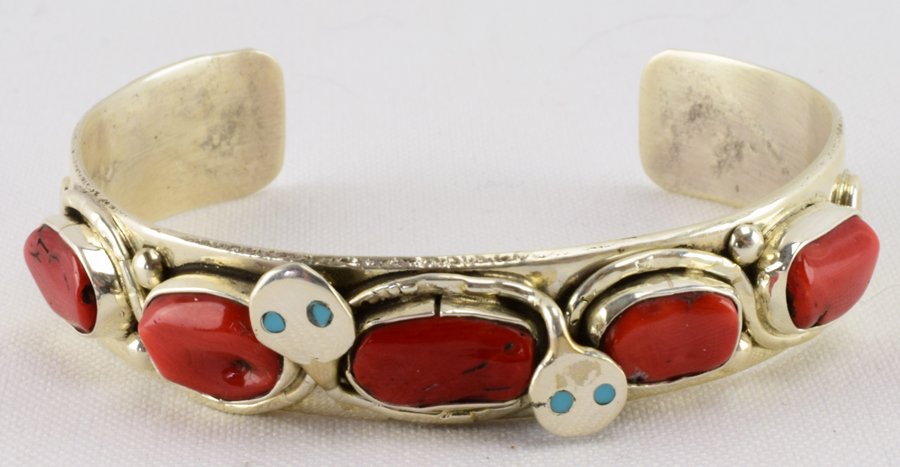 Zuni, Jude Candelaria Sterling Coral Snake Bracelet: Measures 1/2 inch wide with Natural Coral pieces across the top along with the intertwining snake design. The inside measures 5.25 inches plus a gap of 1.25 inches. Stamped Sterling and Signed "Jude C