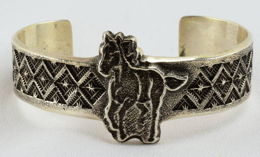 Native American Tufa Cast Horse Bracelet: Measures 1.25 inches in the center and the band is 3/4 inch wide. This piece has a Galloping Horse in the center and a diamond design on the band. Inside measures 5.5 inches plus a gap of 1.25