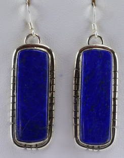 Navajo, Sampson Edsitty Sterling Silver Lapis Earrings: Measuring 1 7/8 inches long with the hook drop these earrings have a center Lapis stone accented with a Notched frame. Stamped Sterling and Hallmarked "SE" for the Navajo Artist Sampson Etsitty. 