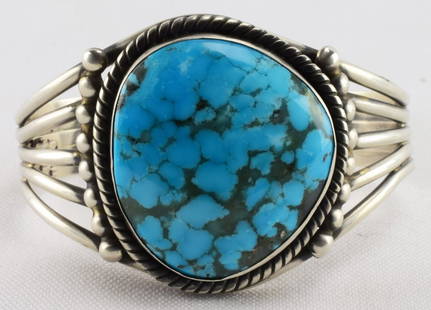 Navajo Lone Mountain Turquoise Sterling Turquoise Cuff: Measures 1.75 inches wide with a Natural Lone Mountain Turquoise Center stone. The center stone is accent with a rope and bead design. The inside measures 5.25 inches plus a gap of 1.5 inches. 