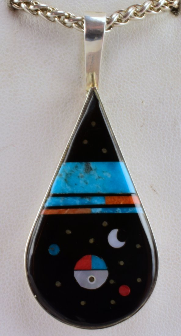 Navajo, Harold Smith, Inlay Night Sky Pendant: Measures 2.5 inches x 1 inch wide at the bottom. This pendant has a Sun Face Center and is Surrounded by the Night Sky. Inlay is Jet, Turquoise, Spiny Oyster and Mother of Pearl. Stamped Sterling and