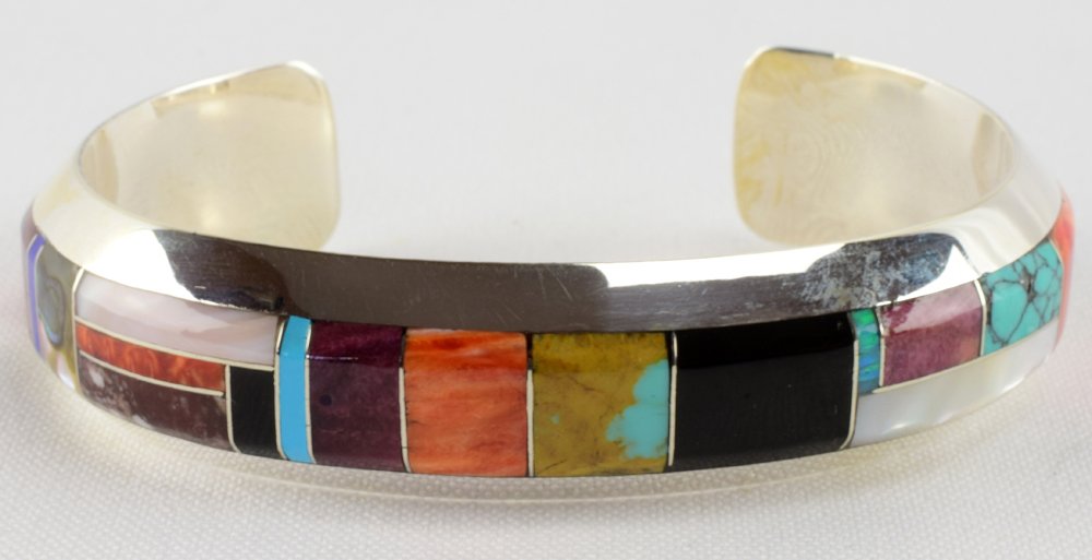 Brian Brown, Sterling Multi-Stone Inlay Cuff Bracelet: Measuring 5/8 inches all around this bracelet has Inlay of Turquoise, Spiny Oyster, Mother of Pearl, Wild Horse Turquoise and jet. The inside measures 5.25 inches plus a gap of 1.25 inches. Stamped St