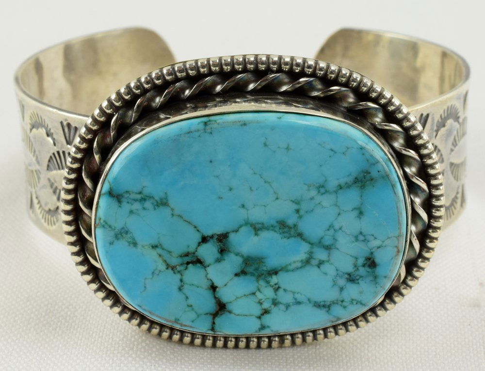 Navajo Sterling Vintage Campitos Turquoise Bracelet: Measuring 1.5 inches in the center this piece has a Natural Campitos Turquoise Mine stone set East to West on the band. The piece is very heavy and has a rope and bead design around the stone. The ban