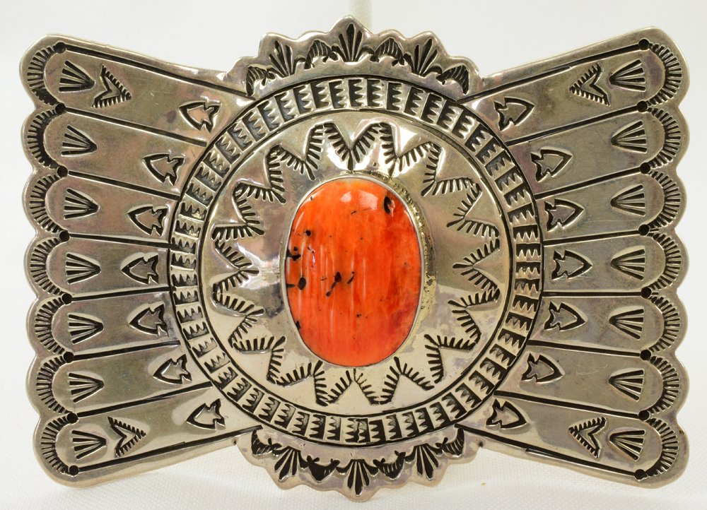 Ronnie Willie Sterling Stamped Lg. Belt Buckle: Measures 3.75 inches wide x 2.5 inches tall. This piece is extremely well made and has a Natural Center Stone of Spiny Oyster. The piece is all completely hand stamped in an "Arrow" style. The keeper 