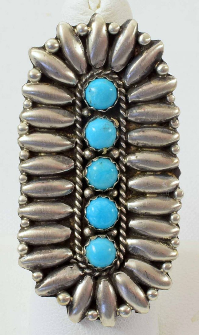Ben Begay Sterling Heavy 5 Stone Sleeping Beauty Ring: Measures 2 inches long x 1 inch wide. This ring has 5 Natural Sleeping Beauty Turquoise cabochons in the center surrounded with Petals of sterling. Stamped Sterling and Signed "B. Begay" Weighs 19.5 G