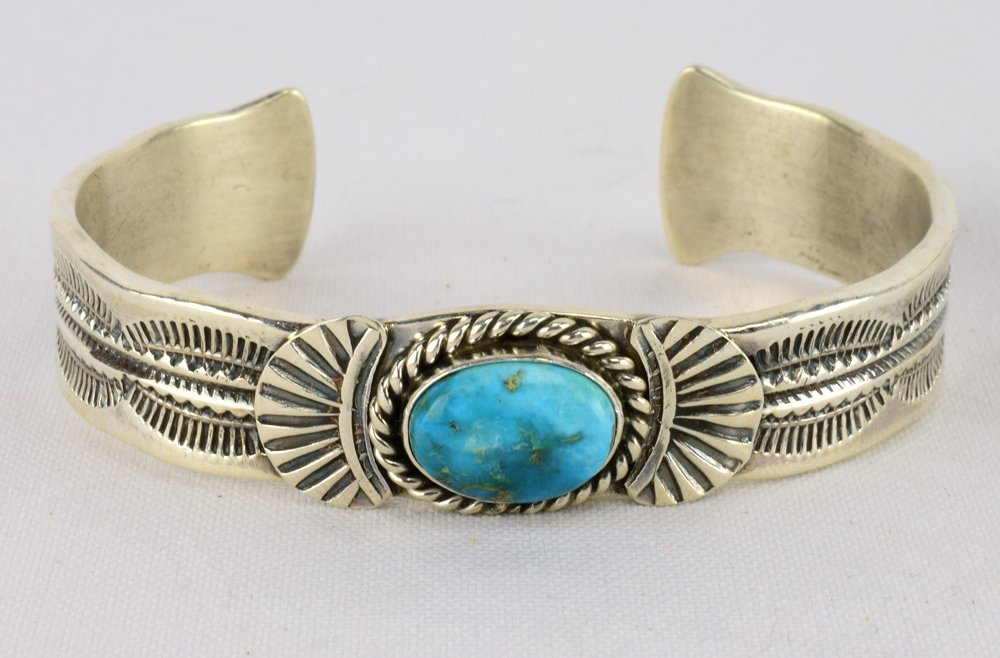 G. Hale Sterling Silver Fox Turquoise Bracelet: Measures 1/2 inch wide with a Natural Fox Turquoise Mine center stone. The stone is accented with a rope and applied sterling design work along with a heavy hand stamped band. Inside measures 5.75 inc