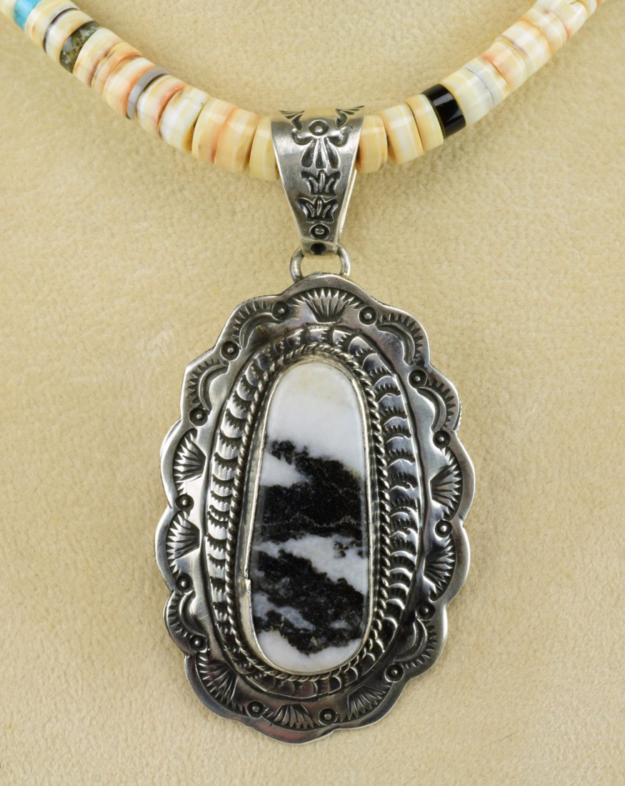 Marcella James Sterling White Buffalo Turquoise Pendant: Measures 3 inches long x 1.5 inches wide this pendant has a White Buffalo Turquoise Center Stone. The stone is accented with a Sterling Stamped frame and a rope design. Stamped Sterling and Signed "Ma