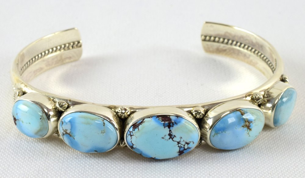 Thomas Francisco Sterling Golden Hills Turq. Bracelet: Measures 1/2 inch wide with 5 Natural Golden Hills Turquoise Stones across the top. We love the light blue electric look this turquoise offers. Inside measures 5.75 inches plus a gap of 1.25 inches. S