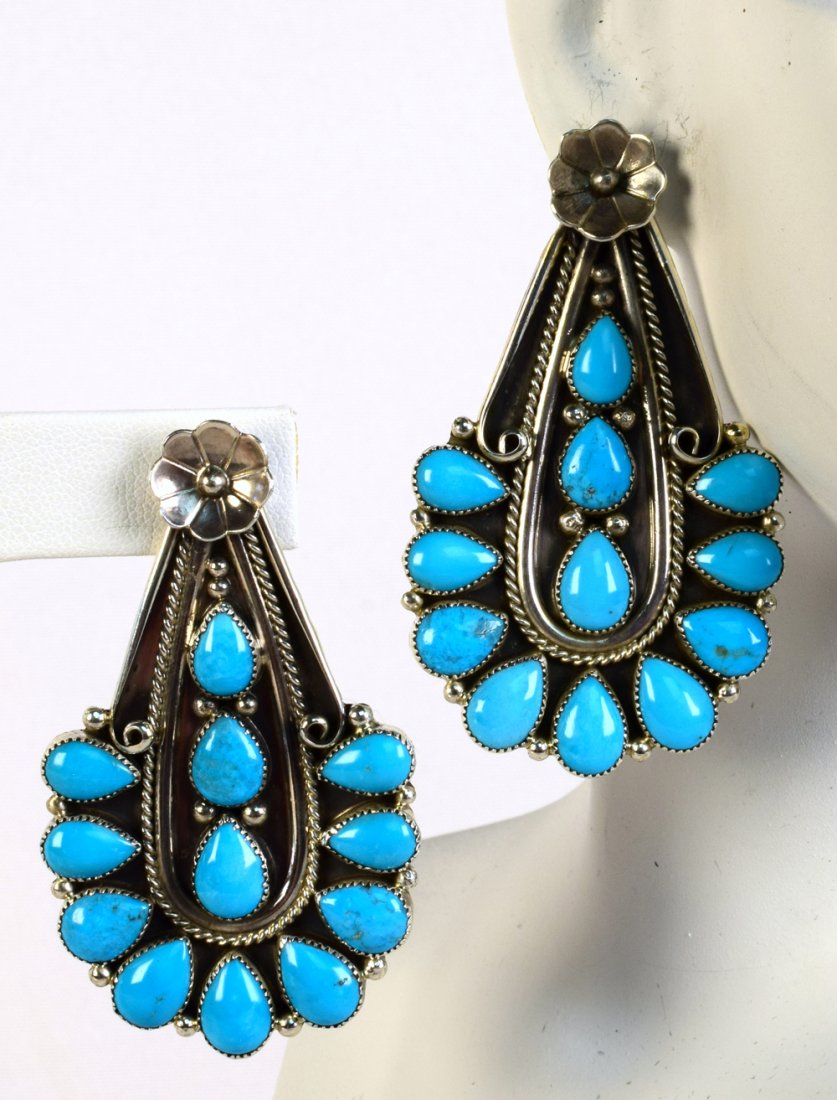 Anthony Skeets Sterling Sleeping Beauty Turq. Earrings: For pierced ears these earrings measure 2.5 inches long x 1.5 inches wide. They have a Cactus flower at the top with rope design work and go into the polished Pear Shape Sleeping Beauty Turquoise ston