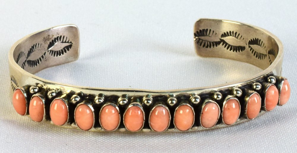 Martha Cayatineto Sterling Peach Coral Bracelet: Measures 1/2 inch wide with Polished Cabochons of Natural Peach Coral bezel set and accented with rain drop beads. Inside measures 5.75 inches plus a gap of 1.25 inches. Stamped Sterling and Hallmarke
