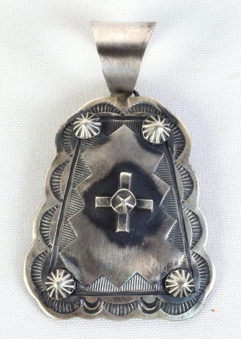 Native American Sterling Cross & Star Concho Pendant: Measures 3.25 inches long x 2 inches wide. This pendant is done with a Cross in the center, Star Concho Beads on the corners and hand stamped design work. Stamped Sterling and Signed "Chimney Butte".