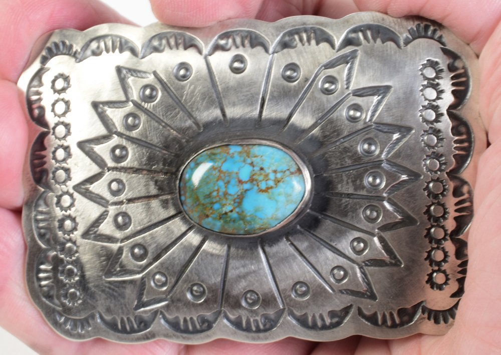 Navajo Sterling Blue Diamond Turquoise Belt Buckle: Measures 3.5 inches x 2.5 inches and has a bezel set Blue Diamond Turquoise center stone. The buckle is deeply hand stamped and done in a Satin Finish. Stamped Sterling and Signed "Chimney Butte". Wei