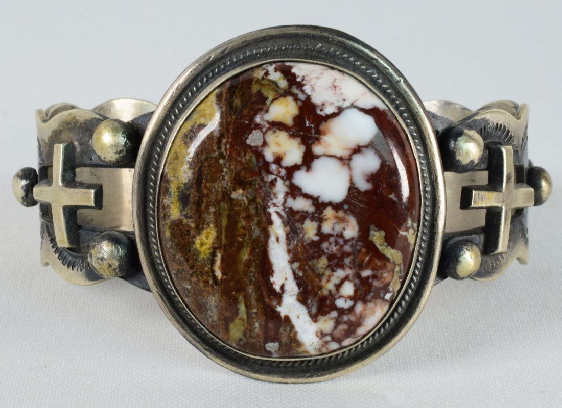 Navajo Sterling Wild Horse Turquoise Bracelet w/Crosses: Measuring 2 inches across with a Wild Horse Turquoise Center stone this bracelet has a stamped frame with bead design and applied Cross pattern on each side. The inside measures 6 inches plus a gap of