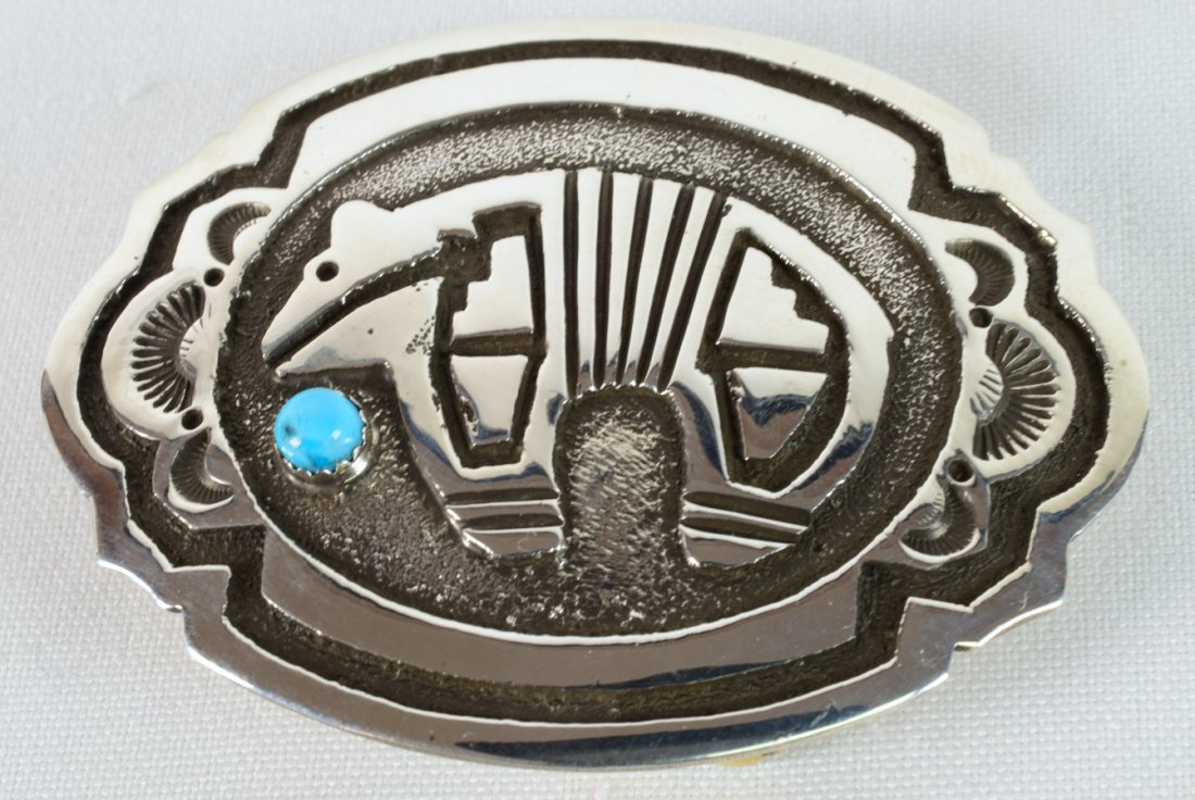 Native American Sterling Overlay Bear Belt Buckle: Measures 2.75 inches wide x 2 1/8 inches tall. This buckle has a tiny Blue Turquoise Cabochon at one side and is done in the Overlay style with the bear. Stamped Sterling and Hallmarked "BK". Weighs 4