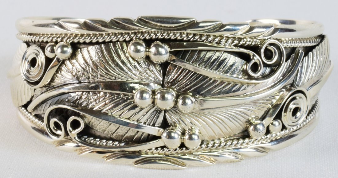 Davy Morgan Sterling Heavy Detailed Feather Cuff: Measures 1.25 inches wide with the entire bracelet accented in applied Feather designs. The piece is accented with scroll and rain drop beads. Inside measures 5.75 inches plus a gap of 1.25 inches. St