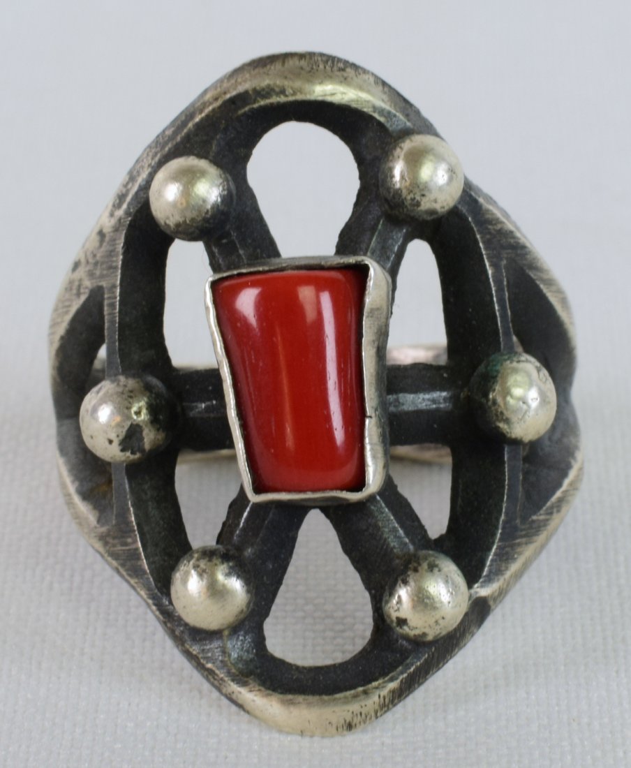 Native American Sterling Tufa Cast Men's Ring w/Coral: Measures 1.25 inches wide and done in a Tufa Cast style this ring has a Natural Coral center stone. Done in the cast style it is more of a Rugged look. Stamped Sterling and Signed "Chimney Butte". Wei