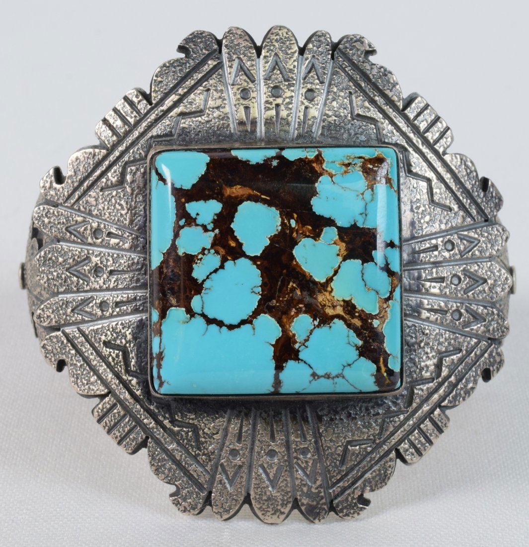 Navajo Sterling Morenci Tufa Cast Overlay Bracelet: This piece is a quality made bracelet that measures 2.5 inches wide and is done with a Tufa Cast top portion that has been Overlaid on the Sterling Band. Looking at it from the sides you can see the t