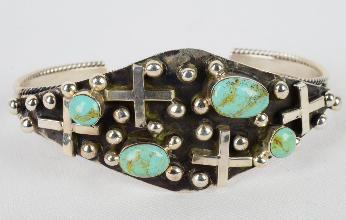 Navajo Sterling Carico Lake Turquoise Cross Bracelet: Measures 1.25 inches wide this piece has four Natural Carico Lake Turquoise cabochons scattered among the Cross and Bead design on the top. Inside measures 5.5 inches plus a gap of 1.25 inches. Stampe