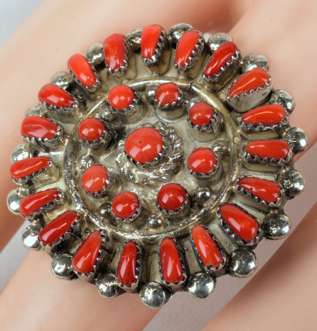 Zuni, Sterling Coral Petit Point and Snake Eye Ring: Measuring 1 3/8 inches in diameter this ring is done in Natural Coral with the outside edge in the the Petit-Point style and the inside pieces are in a Snake Eye Pattern. Each piece is hand cut and se