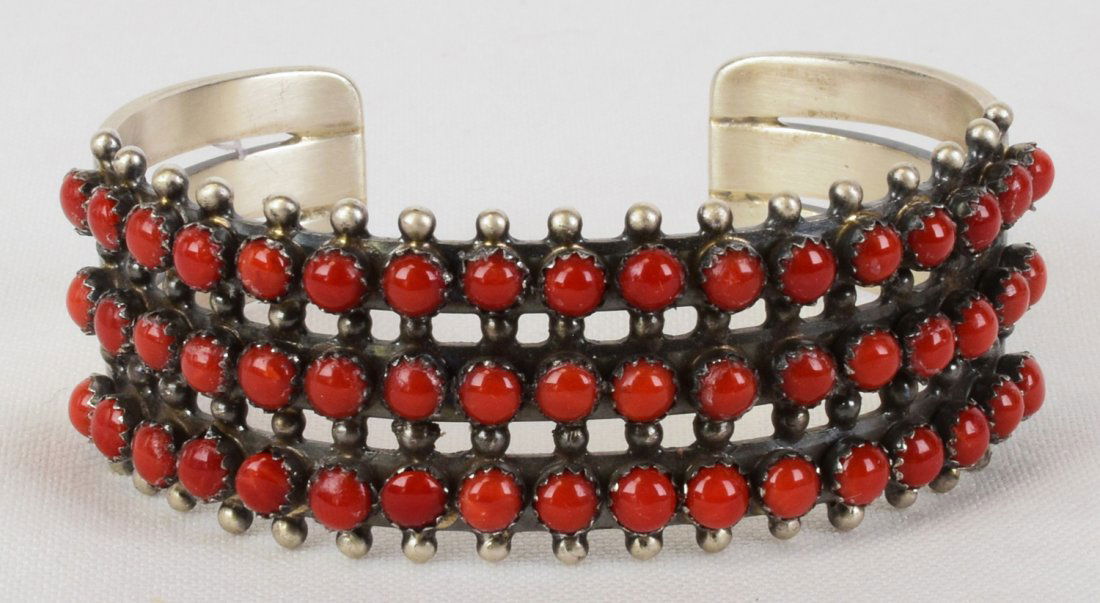 Paul Livingston Sterling Mediterranean Coral Bracelet: Measures 1 inch wide in the center this bracelet is done in Mediterranean Coral pieces across the top. There are a total of 51 Natural Coral pieces beautifully hand set with a small bead accent. Insid