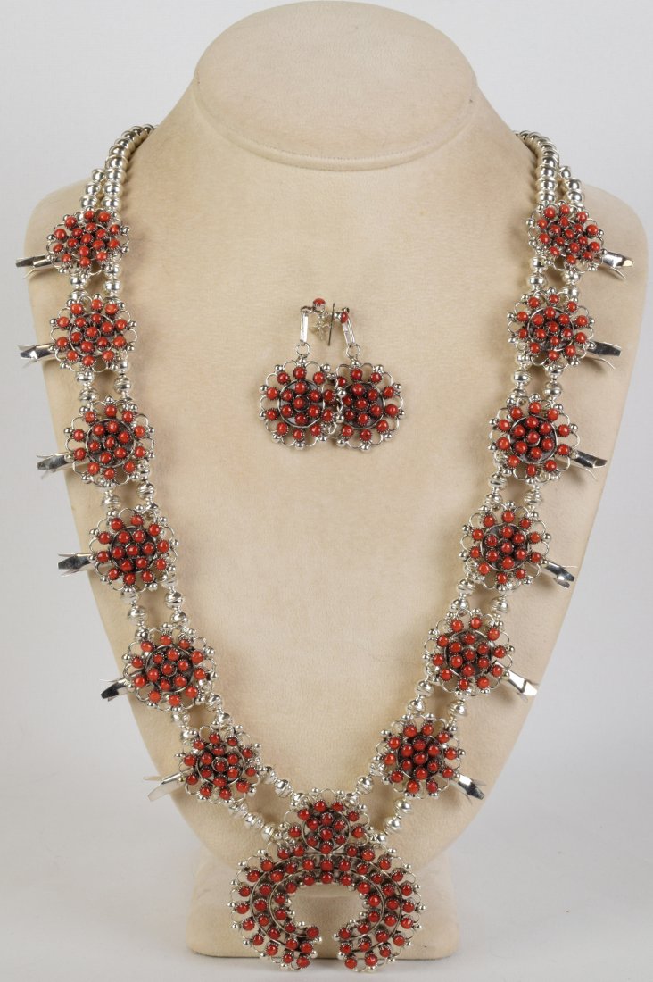 Zuni, Randy Hooee Coral Squash Blossom Necklace Set: Measures 26 inches in length without the Naja Drop. This necklace is done in Mediterranean Coral and in a Snake Eye Pattern. The piece has 6 Blossoms on each side which measure 1.5 inches long x 1 inc