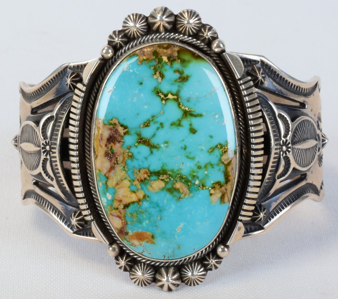 Aaron Toadlena Sterling Royston Turquoise Bracelet: Measures 2.5 inches wide with a Beautiful Royston Turquoise center stone this piece is exceptional and commands attention. The center stone is accented with a Saw Tooth frame and bead design work. The