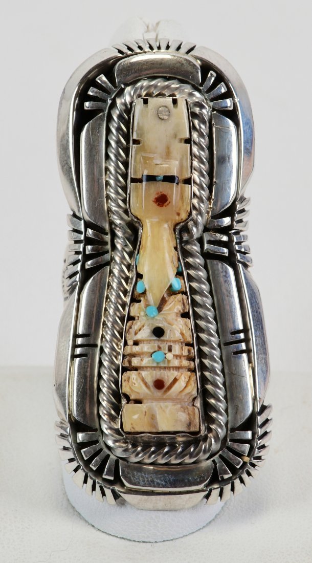 Rita Lee Sterling Carved Bone w/Inlay Corn Maiden Ring: Measures 2.25 inches long x 1 1/8 inches wide. This piece has a hand carved bone center with tiny inlay of Turquoise, Jet and Coral in a Corn Maiden style. The frame is double stacked with sterling an