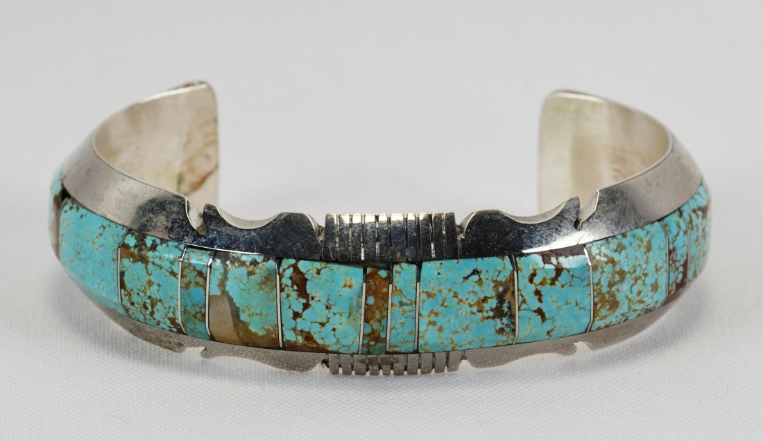 Steve Francisco Inlay No. 8 Turquoise Bracelet: Measures 3/4 inch wide all around with a Sterling Notched Frame. This piece is hand inlaid with No. 8 Turquoise across the piece. Inside measures 5.25 inches plus a gap of 1.25 inches. Sterling Silver