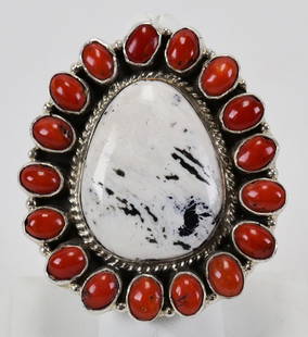 Geraldine James White Buffalo Turquoise & Coral Ring: Measuring 2 inches long x 1.75 inches wide. This is an impressive piece with the White Buffalo Turquoise Center accented with the Mediterranean Coral Cabochons. Sterling Silver, Signed and Weighs 39 G