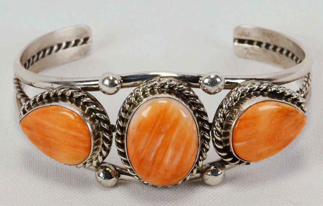 Native American Sterling Spiny Oyster Bracelet: Measures 1 inch wide and has Three Spiny Oyster stones accented with rope and bead design. Inside measures 5.5 inches plus a gap of 1.25 inches. Sterling, Hallmarked "SE" for Samson Edsitty and Weighs