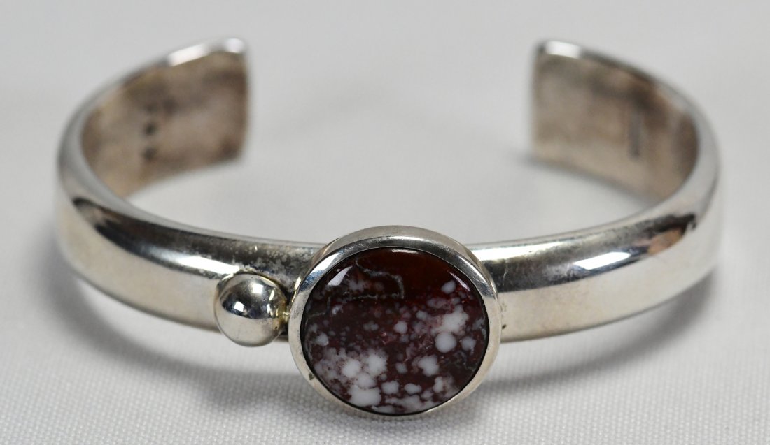 Navajo Sterling Silver Heavy Wild Horse Bracelet: Measures 3/4 inch wide across the top. This piece has a very heavy gauge Sterling Smooth band and a Bezel Set Wild Horse Turquoise Center stone with a bead accent. Inside measures 5 3/8 inches plus a 
