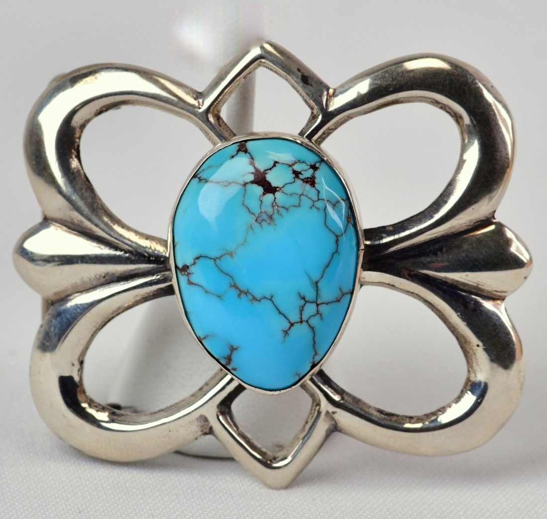 Chimney Butte Sterling Kingman Turquoise Belt Buckle: Measures 2.75 inches wide x 2.25 inches tall. This piece is done in a High Polished Sterling Finish with a Natural Domed Kingman Turquoise Center stone. Sterling Silver/Signed and Weighs 52 Grams. Nat