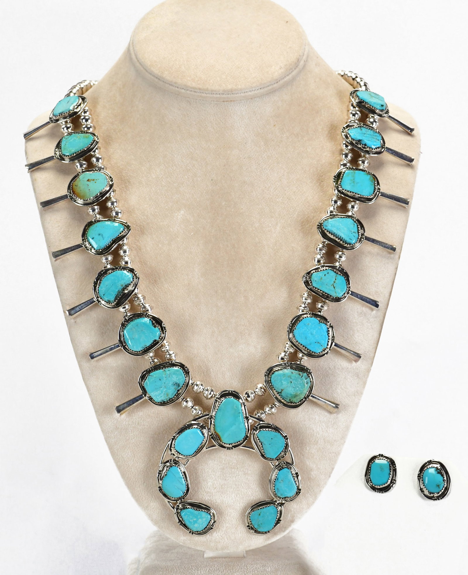 Navajo Sterling Silver Lone Mountain Turquoise Squash Blossom Necklace: Sterling Silver| Navajo Sterling Silver Kingman Turquoise Squash Blossom Necklace Set| Genuine Lone Mountain Turquoise| Measures 23" in length {without the Naja Drop}| Has 7 Blossoms on each side meas