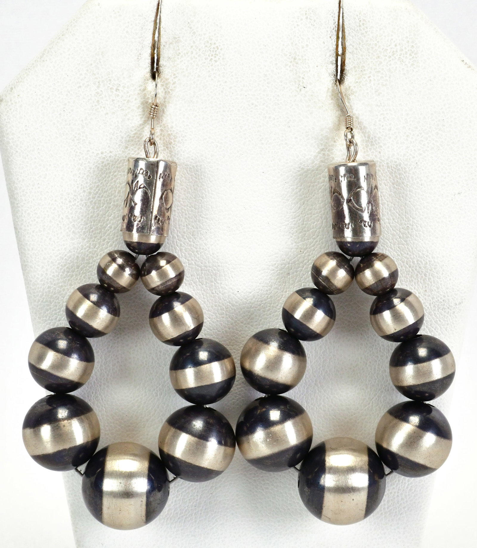 Native American Sterling Silver Bench Bead Hoop Stye Earrings: Sterling Silver| Native American Sterling Silver Bench Bead Hoop Style Earrings| All Sterling Silver| Measures 3.25" Long x 1.5" Wide| Beads are Satin Finished and Graduate 4 to 12 mm. Unsigned| Weigh