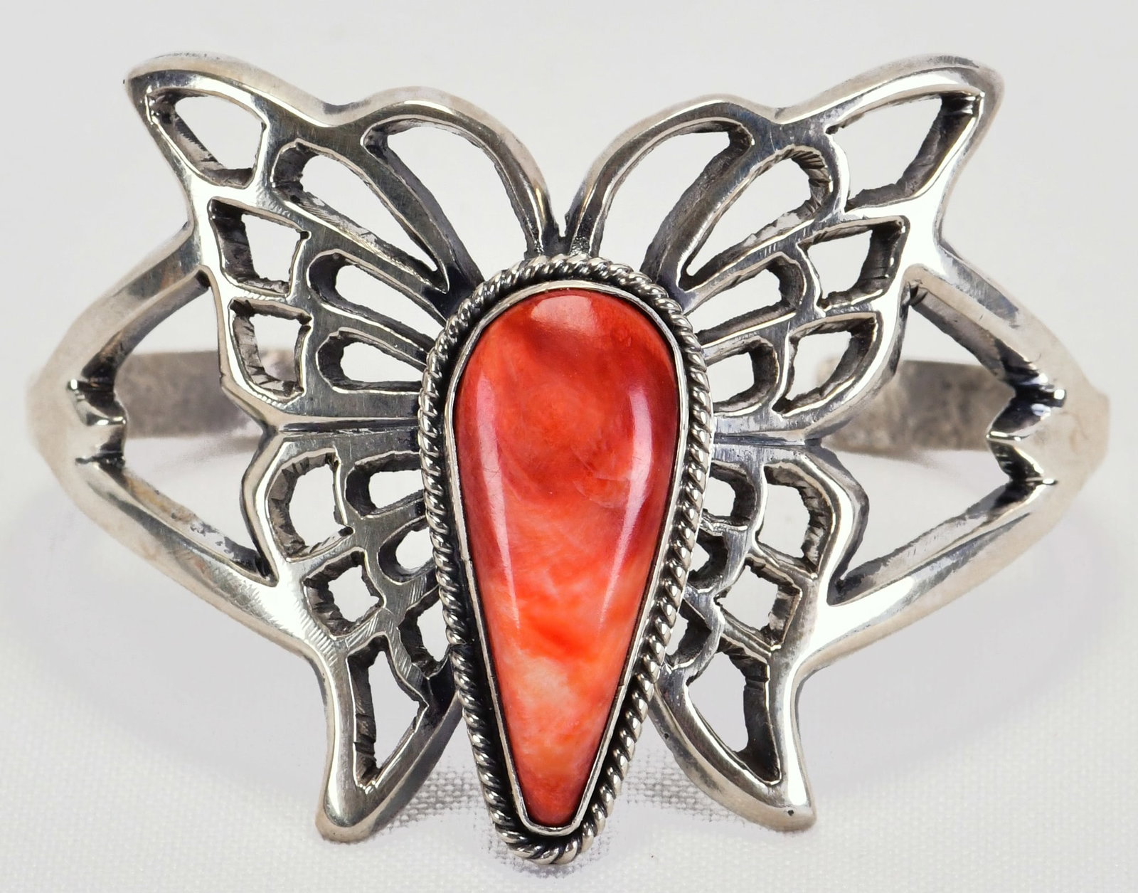 E. S. Mitchell, Navajo Sterling Silver Spin Oyster Butterfly Bracelet: Sterling Silver| E. S. Mitchell Sterling Silver Spiny Oyster Butterfly Bracelet| Genuine Spiny Oyster| Inside measures 5" plus a gap of 1.25" - Total 6.25" Face Width 1.75"| Signed| Weighs 45 Grams| N