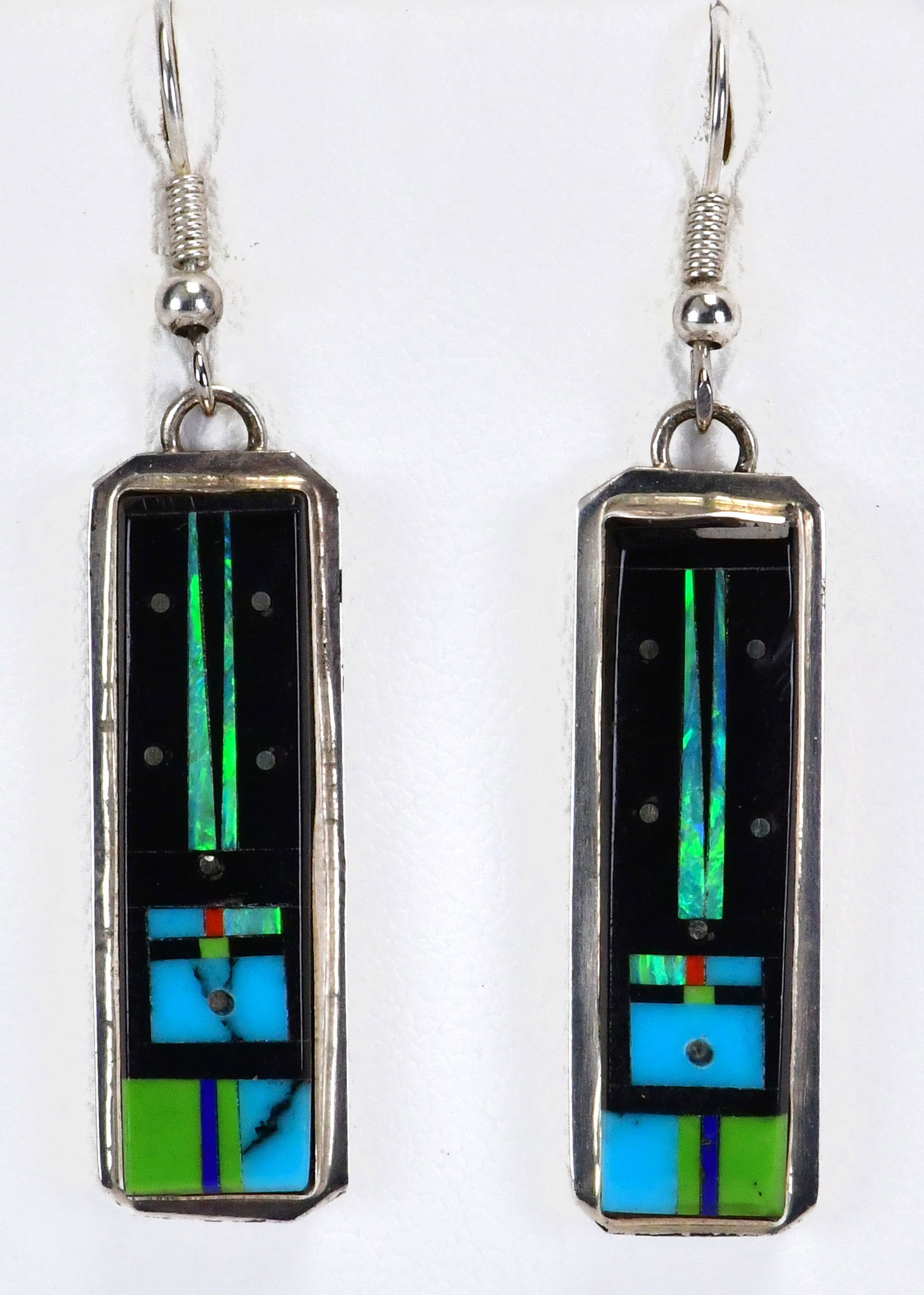 Gilbert Smith Sterling Silver Micro Inlay Kachina Earrings: Sterling Silver| Gilbert Smith Sterling Silver Micro Inlay Kachina Earrings| Genuine Turquoise, Coral, Mother of Pearl & Jet| Measures 2" Long x 1/4" Wide| Hallmarked "S"| Weigh 6 Grams| Native Americ