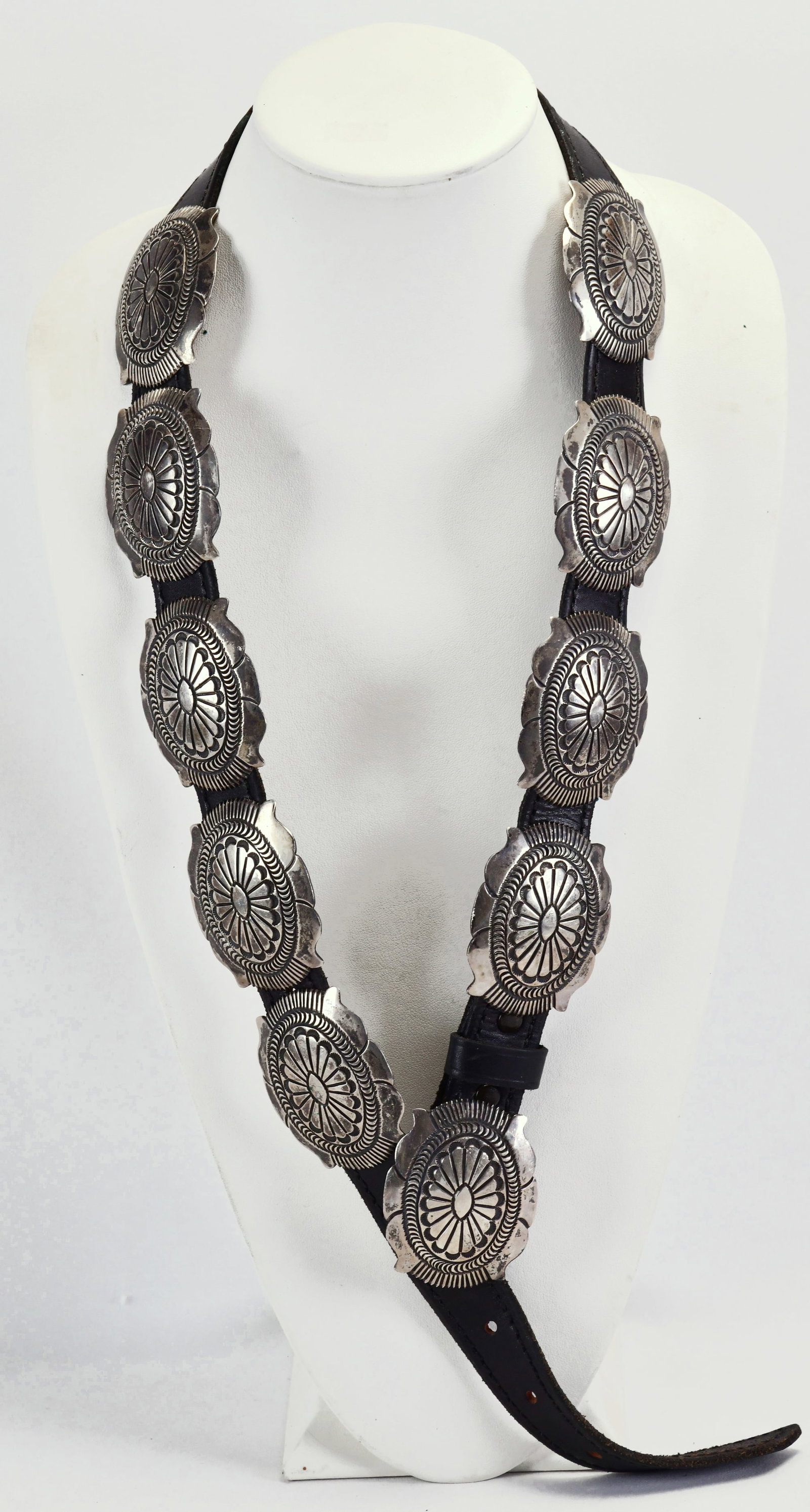 Navajo Sterling Silver Old Pawn Concho Belt: Sterling Silver| Navajo Sterling Silver Old Pawn Deep Stamped Concho Belt| Genuine Sterling Silver| Measures 41" Long| Buckle measures 2.5" Wide x 2" Tall| Nine Concho Pieces measure 2.5" Wide x 2" Ta