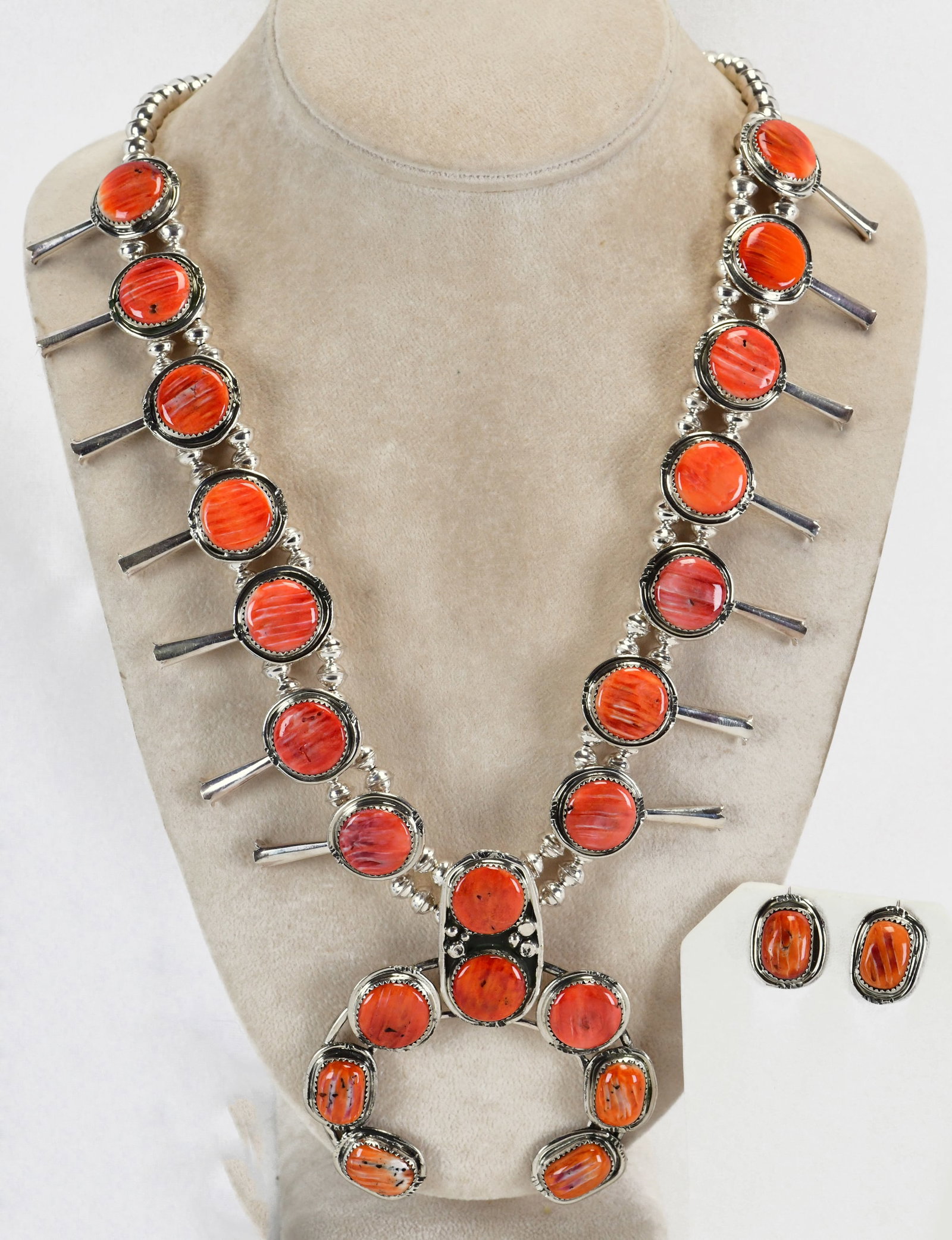 Phillip Yazzie Sterling Silver Spiny Oyster Squash Blossom Necklace Set: Sterling Silver| Phillip Yazzie Sterling Silver Spiny Oyster Squash Blossom Necklace Set| Genuine Spiny Oyster| Measures 23" Long {Without the Naja Drop}| Has 7 Blossoms on each side - Measuring 1.5" 