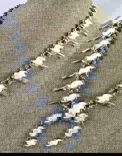 Navajo Sterling Silver White Buffalo Block Turquoise Squash Blossom Necklace Set: Sterling Silver| Navajo Sterling Silver Block White Buffalo Turquoise Necklace Set| Block White Buffalo Turquoise| Measures 22" in length {Without the Naja Drop}| Has 7 Blossoms on each side that meas