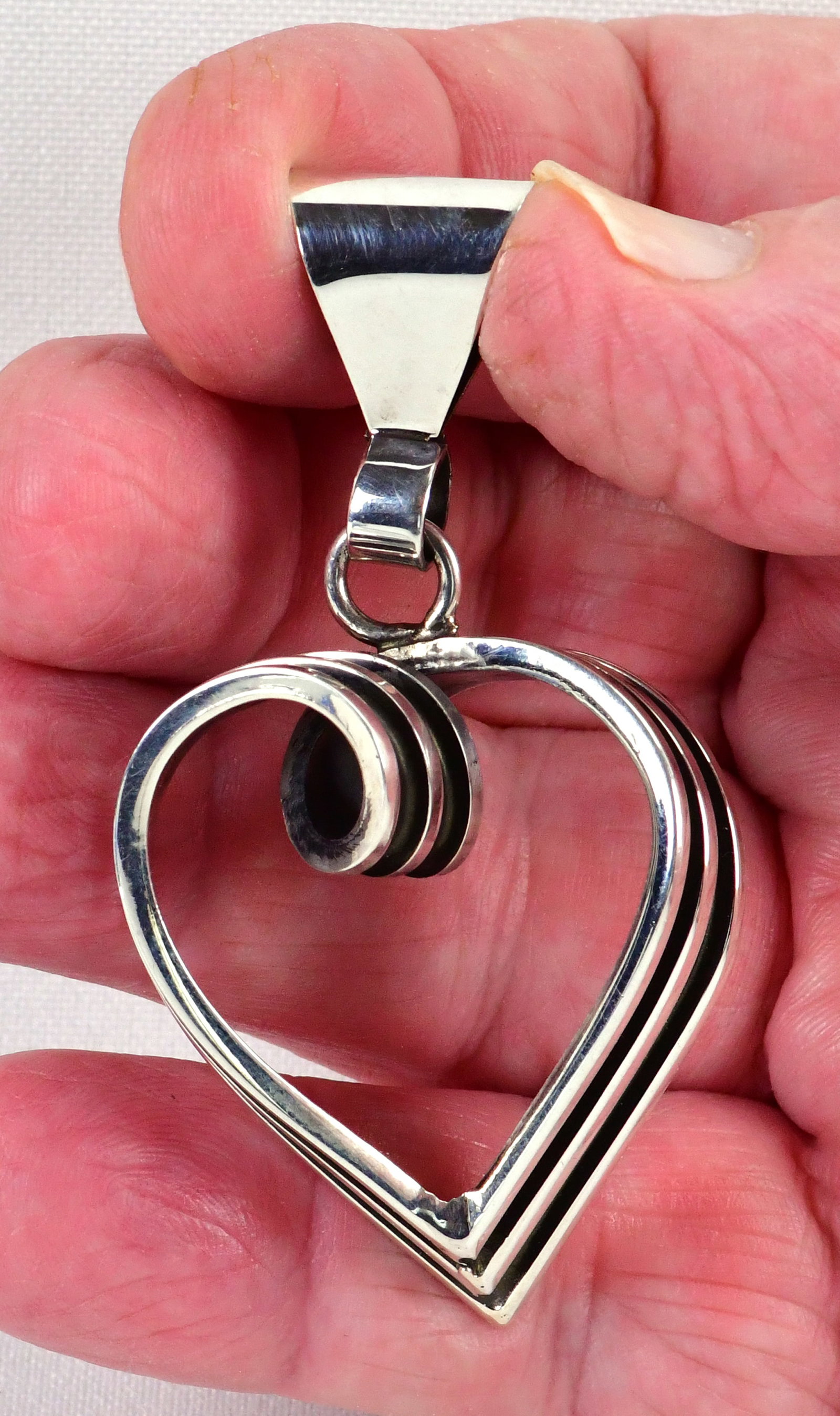 Navajo, Tom Hawk Sterling Double Groove Twisted Heart Pendant: Pendant Only - Sterling Silver| Tom Hawk Sterling Silver Double Groove twisted Heart Pendant| All Sterling Silver| Measures 3" Long x 1.5" Wide| Signed| Weighs 21.6 Grams| Native American, Navajo, Sou