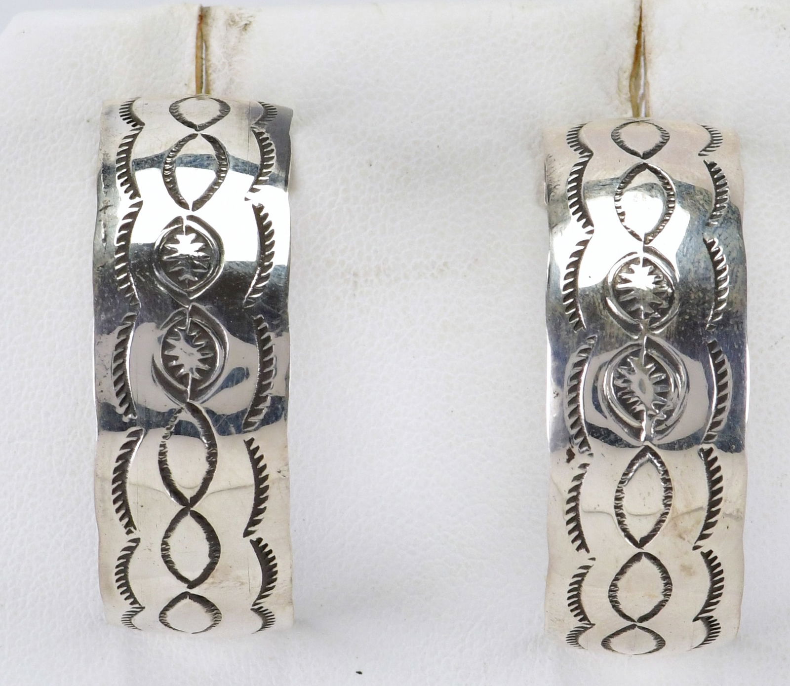 Native American Sterling Silver Stamped Half Hoop Earrings: Sterling Silver| Native American Sterling Silver Stamped Half Hoop Earrings| All Sterling Silver| Measures 1/2" Wide and has a drop of 1.5"| Hallmarked "JC"| Weigh 13.7 Grams| Native American, Navajo,